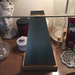 Gold necklace display with wooden base